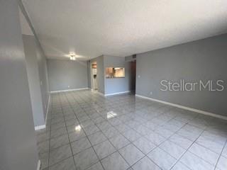 tiled spare room with baseboards