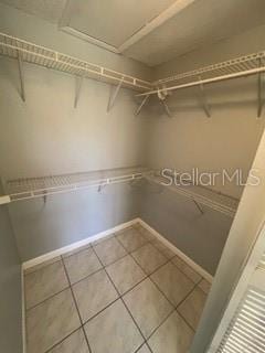 spacious closet featuring tile patterned floors