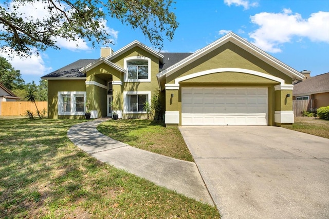 9603 Sunnyoak Dr, Riverview, FL 33569 - view of front of home with concrete driveway, fence, stucco siding, and a front yard