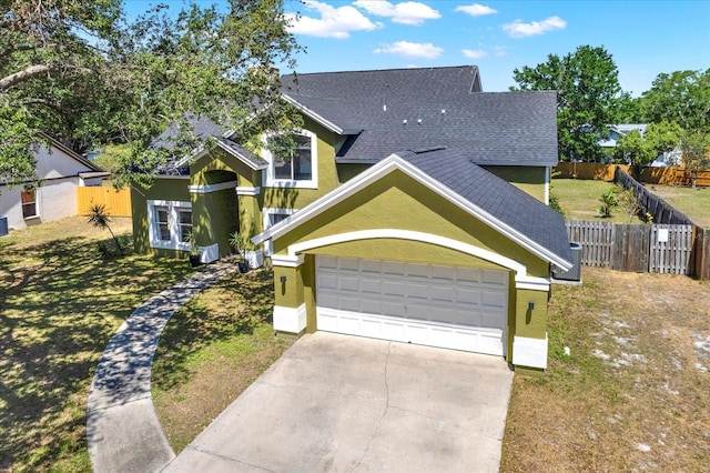9603 Sunnyoak Dr, Riverview, FL 33569 - view of front of home featuring an attached garage, roof with shingles, stucco siding, and driveway
