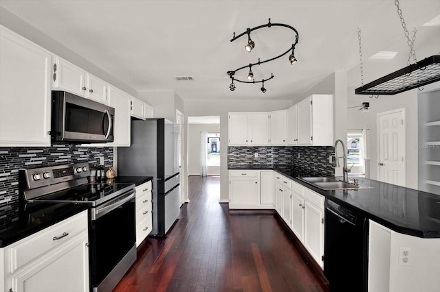 9603 Sunnyoak Dr, Riverview, FL 33569 - kitchen featuring a peninsula, a sink, dark countertops, ceiling fan, and appliances with stainless steel finishes