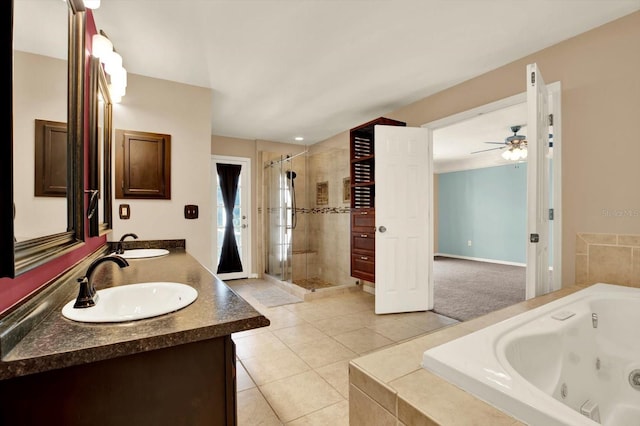 9603 Sunnyoak Dr, Riverview, FL 33569 - bathroom with a tub with jets, tile patterned floors, a sink, and a stall shower