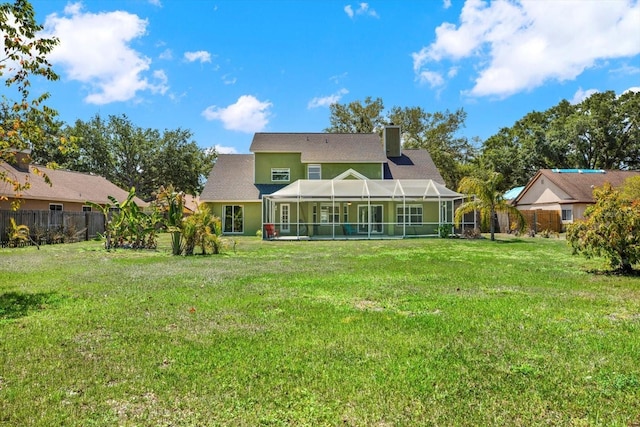 9603 Sunnyoak Dr, Riverview, FL 33569 - rear view of property featuring a yard, a lanai, a chimney, and fence