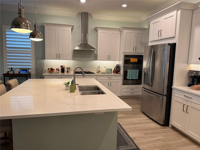 kitchen featuring stainless steel refrigerator with ice dispenser, a sink, wall chimney exhaust hood, recessed lighting, and light wood-style floors