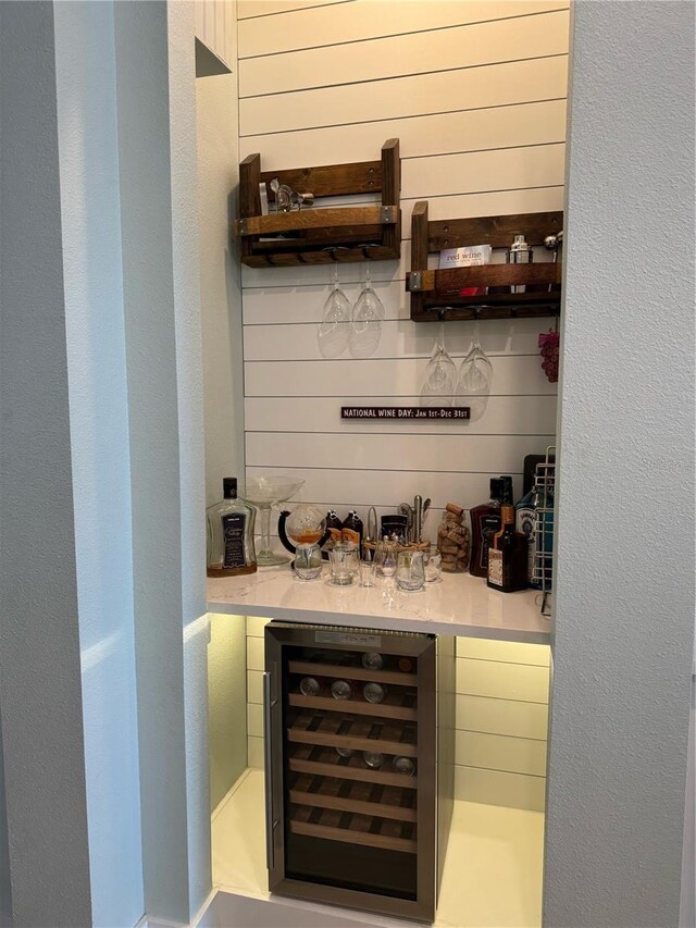 indoor dry bar with wine cooler and wooden walls