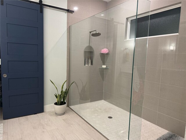 bathroom featuring walk in shower and wood finished floors