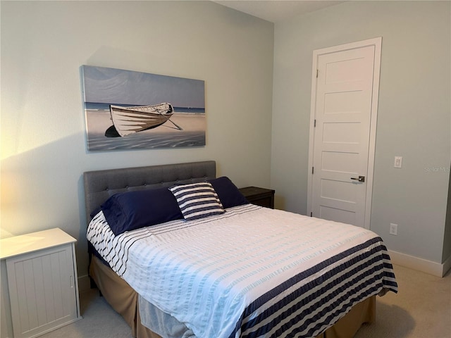 bedroom featuring carpet and baseboards