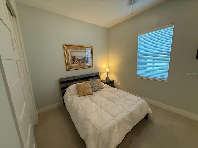 carpeted bedroom with baseboards
