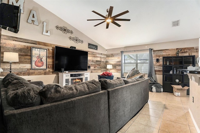 13416 Algoma Ave, Spring Hill, FL 34609 - living area with ceiling fan, lofted ceiling, light tile patterned floors, and a lit fireplace