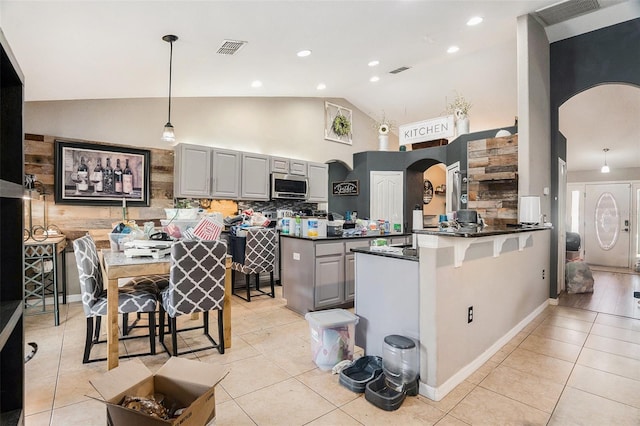 13416 Algoma Ave, Spring Hill, FL 34609 - kitchen featuring stainless steel microwave, gray cabinetry, arched walkways, dark countertops, and recessed lighting