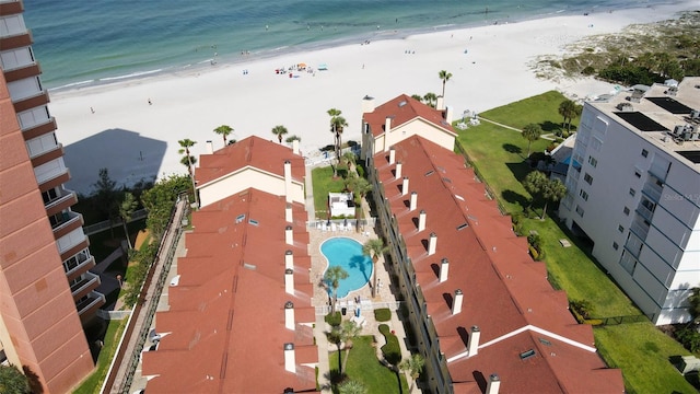 birds eye view of property with a beach view and a water view