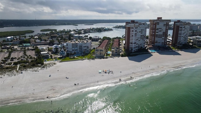drone / aerial view featuring a beach view and a water view