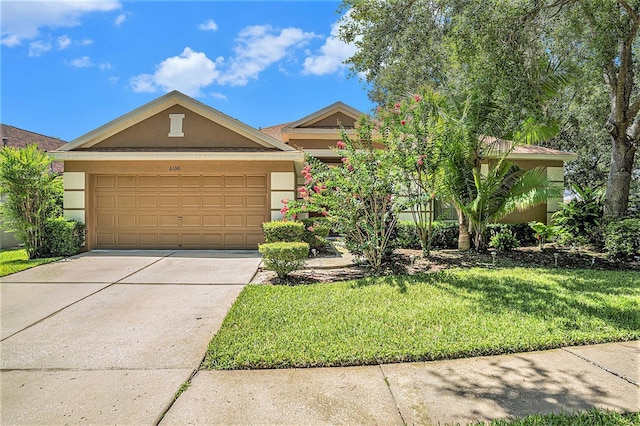 6130 Whimbrelwood Dr, Lithia, FL 33547 - view of front of home featuring stucco siding, a front lawn, driveway, and an attached garage