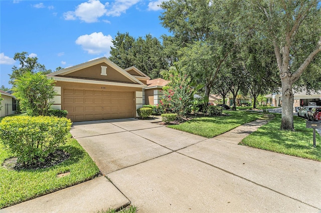 6130 Whimbrelwood Dr, Lithia, FL 33547 - obstructed view of property with stucco siding, concrete driveway, a garage, and a front yard