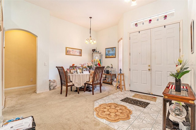 6130 Whimbrelwood Dr, Lithia, FL 33547 - dining space with arched walkways, a chandelier, and carpet floors