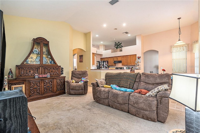 6130 Whimbrelwood Dr, Lithia, FL 33547 - living area with arched walkways, light colored carpet, and recessed lighting