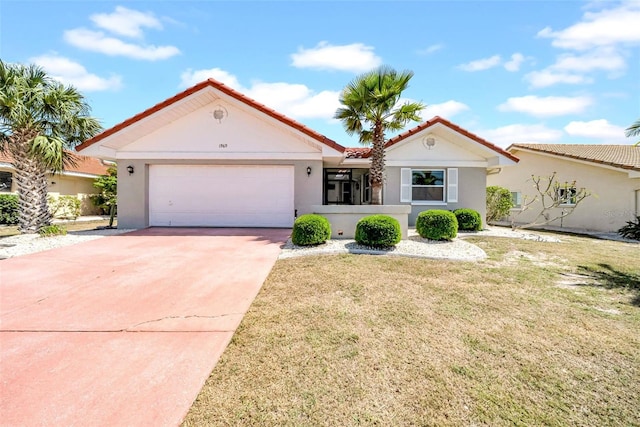 1969 Wolf Laurel Dr, Sun City Center, FL 33573 - view of front of home featuring concrete driveway, a garage, and stucco siding