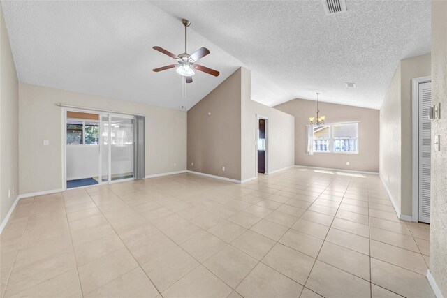 1969 Wolf Laurel Dr, Sun City Center, FL 33573 - unfurnished living room featuring visible vents, ceiling fan with notable chandelier, light tile patterned floors, and lofted ceiling