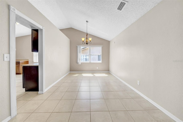 1969 Wolf Laurel Dr, Sun City Center, FL 33573 - unfurnished dining area featuring visible vents, light tile patterned floors, an inviting chandelier, a textured ceiling, and vaulted ceiling