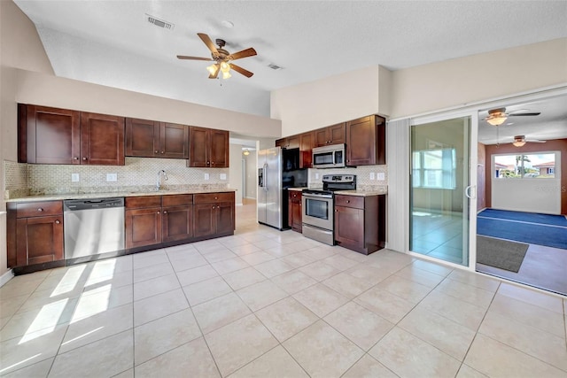 1969 Wolf Laurel Dr, Sun City Center, FL 33573 - kitchen with visible vents, backsplash, appliances with stainless steel finishes, and a ceiling fan