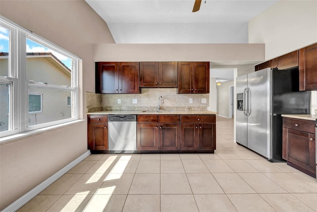 1969 Wolf Laurel Dr, Sun City Center, FL 33573 - kitchen with appliances with stainless steel finishes, a sink, backsplash, and lofted ceiling