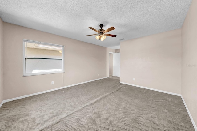 1969 Wolf Laurel Dr, Sun City Center, FL 33573 - spare room featuring a textured ceiling, a ceiling fan, visible vents, and carpet floors