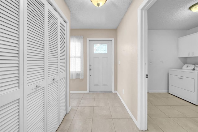 1969 Wolf Laurel Dr, Sun City Center, FL 33573 - foyer entrance featuring light tile patterned floors, a textured ceiling, and baseboards