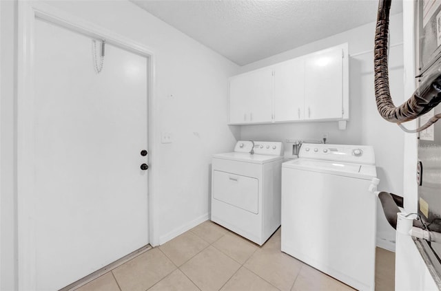 1969 Wolf Laurel Dr, Sun City Center, FL 33573 - washroom featuring baseboards, a textured ceiling, cabinet space, washing machine and dryer, and light tile patterned flooring