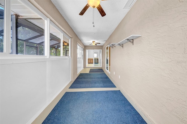 1969 Wolf Laurel Dr, Sun City Center, FL 33573 - corridor with a textured ceiling, visible vents, a textured wall, and carpet
