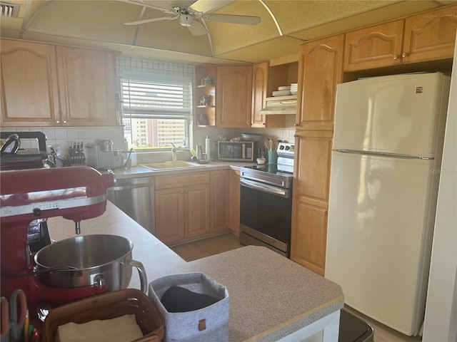 4725 Cove Cir Unit 810, Saint Petersburg, FL 33708 - kitchen featuring open shelves, light countertops, a ceiling fan, a sink, and appliances with stainless steel finishes