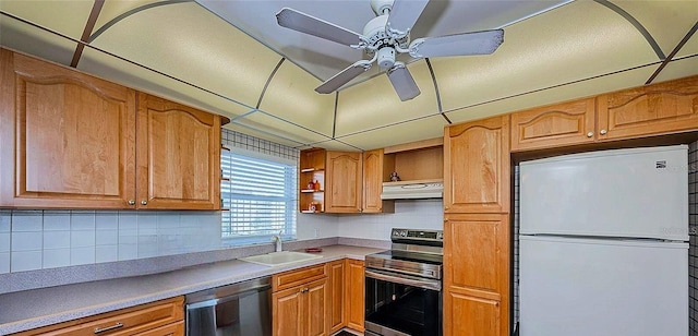 4725 Cove Cir Unit 810, Saint Petersburg, FL 33708 - kitchen with a sink, ceiling fan, stainless steel appliances, backsplash, and under cabinet range hood