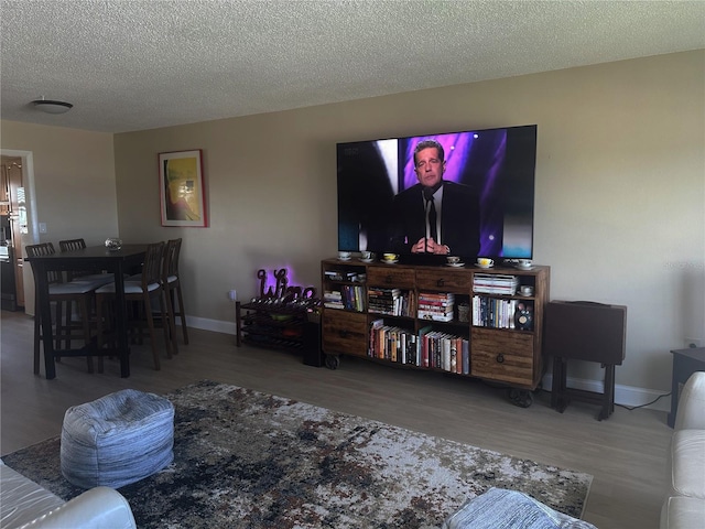 4725 Cove Cir Unit 810, Saint Petersburg, FL 33708 - living area featuring baseboards, wood finished floors, and a textured ceiling