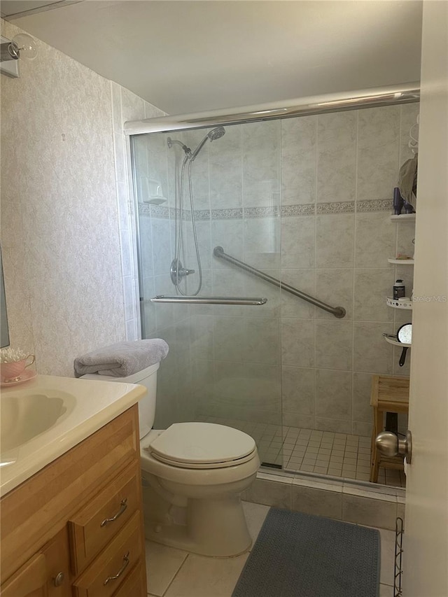 4725 Cove Cir Unit 810, Saint Petersburg, FL 33708 - bathroom featuring toilet, vanity, tile patterned floors, and a stall shower