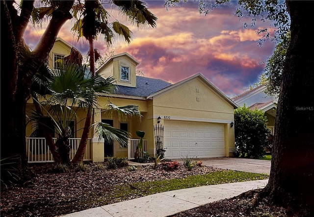 6230 Gannetdale Dr, Lithia, FL 33547 - view of front of home featuring driveway, stucco siding, a garage, and a shingled roof