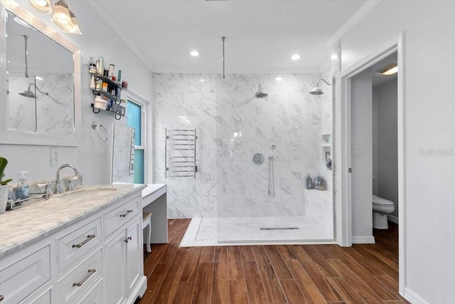 6230 Gannetdale Dr, Lithia, FL 33547 - bathroom with a marble finish shower, ornamental molding, vanity, wood finished floors, and recessed lighting