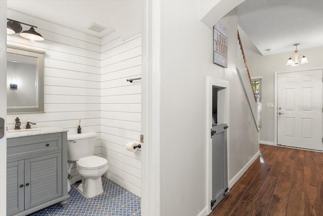 6230 Gannetdale Dr, Lithia, FL 33547 - bathroom with vanity, wooden walls, and wood finished floors