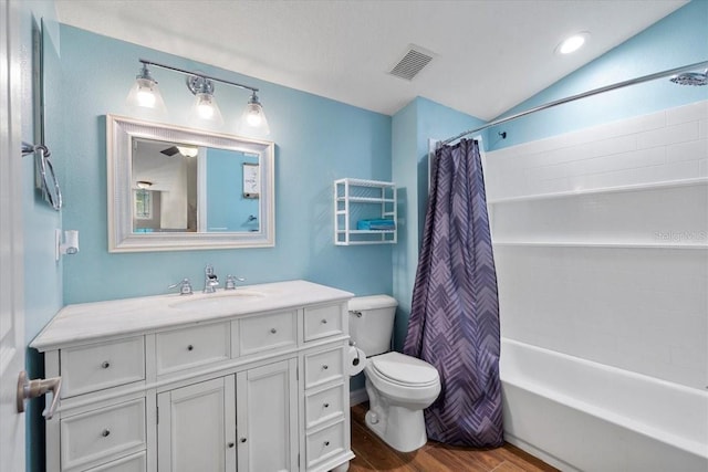 6230 Gannetdale Dr, Lithia, FL 33547 - bathroom featuring wood finished floors, vanity, shower / bath combo, and vaulted ceiling