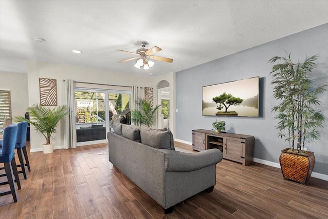 6230 Gannetdale Dr, Lithia, FL 33547 - living room featuring ceiling fan, dark wood-style flooring, and arched walkways