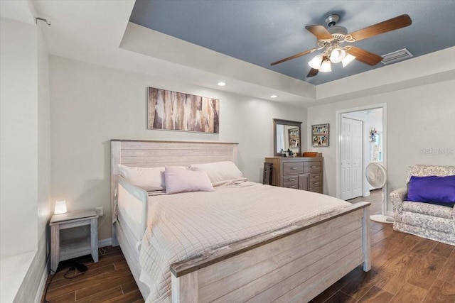 6230 Gannetdale Dr, Lithia, FL 33547 - bedroom with a tray ceiling, dark wood-style floors, recessed lighting, a ceiling fan, and a closet