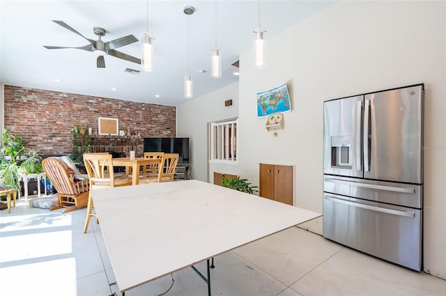 3302 W Caracas St, Tampa, FL 33614 - kitchen with stainless steel fridge with ice dispenser, brick wall, a ceiling fan, and hanging light fixtures