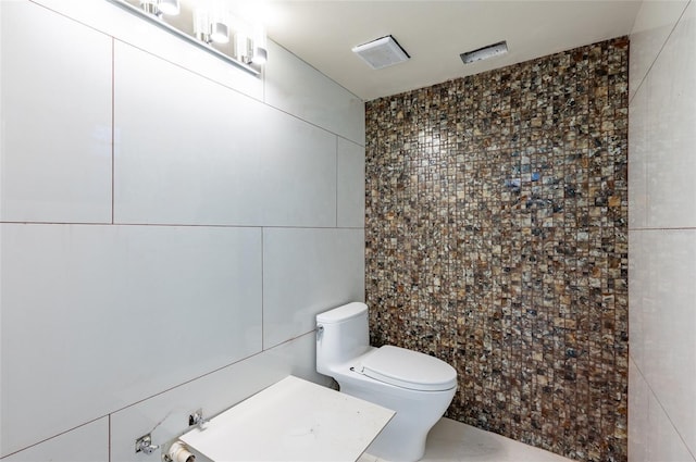 3302 W Caracas St, Tampa, FL 33614 - bathroom with tile walls, toilet, and a tile shower