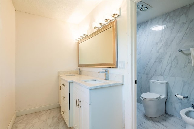 3302 W Caracas St, Tampa, FL 33614 - bathroom with marble look tile flooring, a bidet, toilet, double vanity, and tile walls