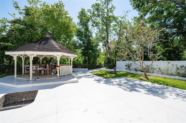 3302 W Caracas St, Tampa, FL 33614 - view of home's community featuring a patio area, a fenced backyard, a gazebo, and view of wooded area