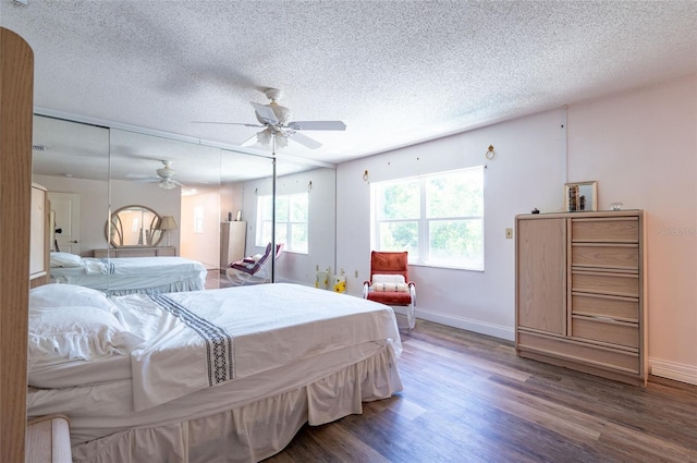3302 W Caracas St, Tampa, FL 33614 - bedroom featuring wood finished floors, a textured ceiling, baseboards, and ceiling fan