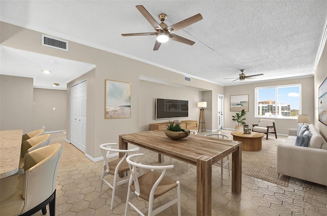 living area featuring light tile patterned floors, visible vents, a ceiling fan, and crown molding