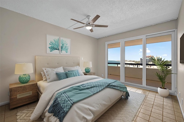 bedroom featuring a textured ceiling, access to exterior, baseboards, light tile patterned flooring, and a ceiling fan