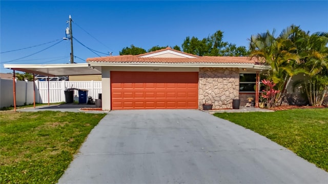 1469 S Hillcrest Ave, Clearwater, FL 33756 - view of front facade featuring a tile roof, an attached garage, concrete driveway, and stone siding