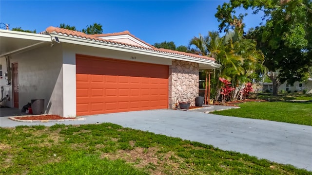 1469 S Hillcrest Ave, Clearwater, FL 33756 - view of front of home featuring stucco siding, a front lawn, an attached garage, stone siding, and concrete driveway