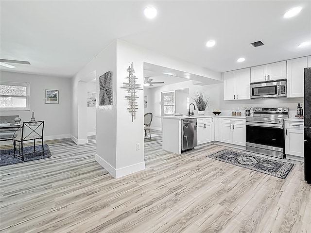 1469 S Hillcrest Ave, Clearwater, FL 33756 - kitchen with appliances with stainless steel finishes, ceiling fan, light wood-style floors, light countertops, and recessed lighting