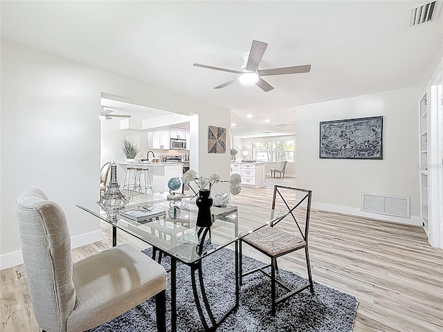 1469 S Hillcrest Ave, Clearwater, FL 33756 - dining space with ceiling fan, baseboards, and light wood-style floors